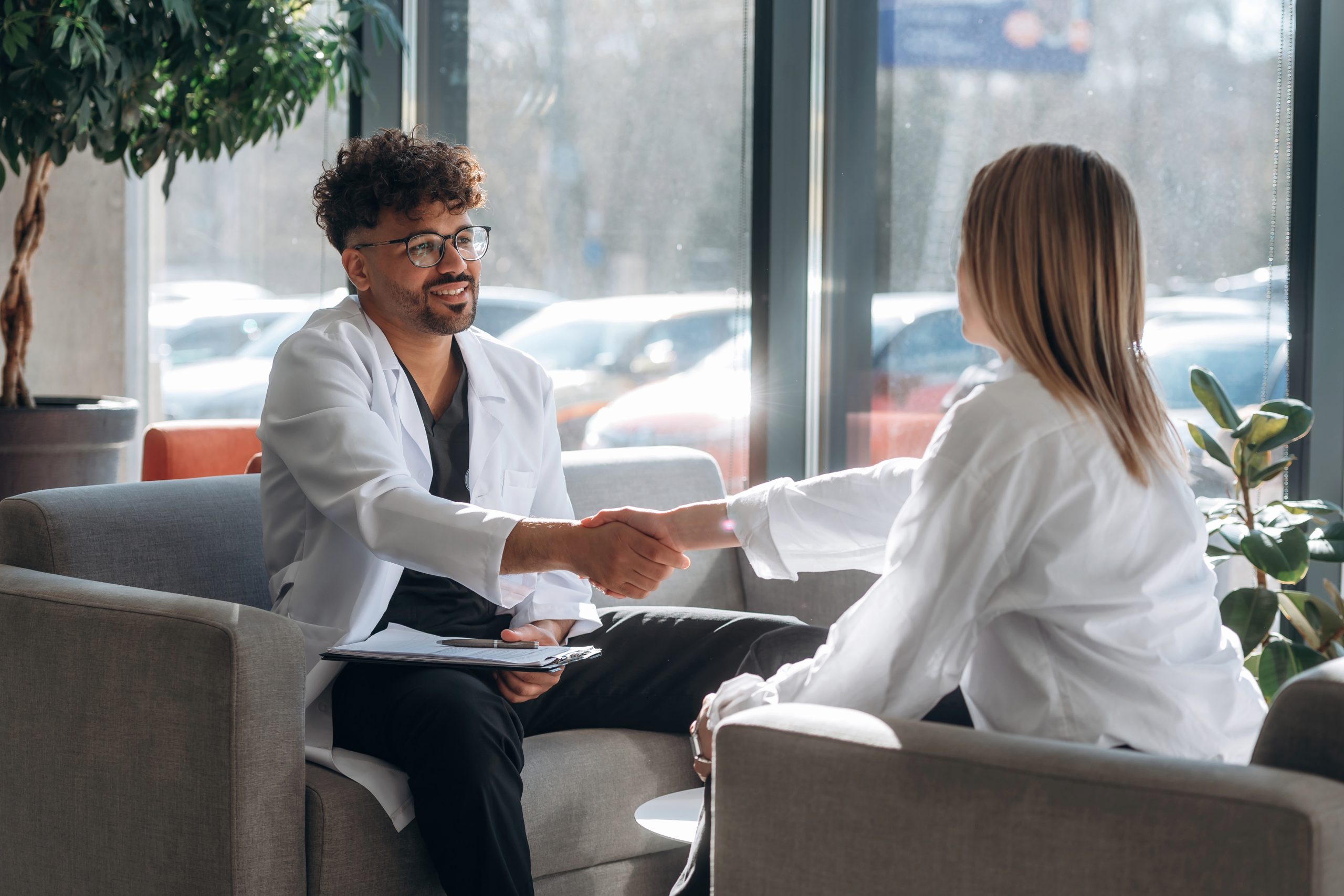 A man and woman shaking hands, forming a partnership focused on holistic care in York PA.
