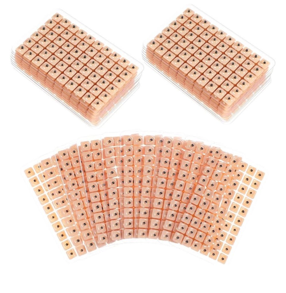 Clear plastic trays hold small wooden cubes, each with a single black dot, arranged in stacks and a fan shape on a white background—an organized approach reminiscent of integrative medicine or holistic care in York PA.
